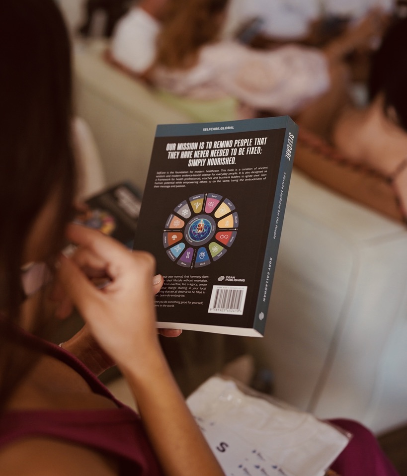 A reader holding the SelfCare book
