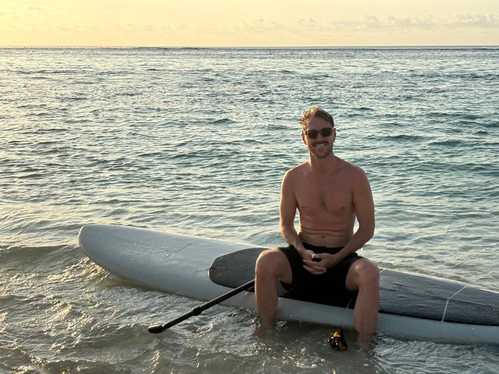 Rory on a paddleboard at sunset